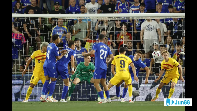 Barca and Getafe players fighting for the ball during a crucial moment in the match